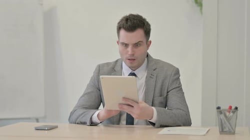 Man Reacts to Bad News on Tablet