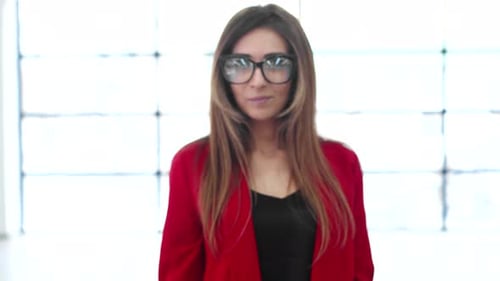 Woman Holding House Keys Out in Bright Room