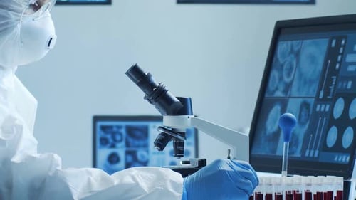 Scientist Analyzing Blood Sample in Bright Lab