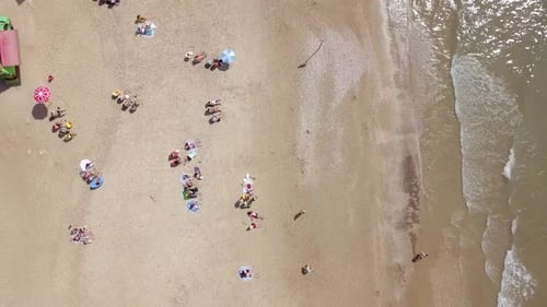 Mediterranean beach during summer with people in the water