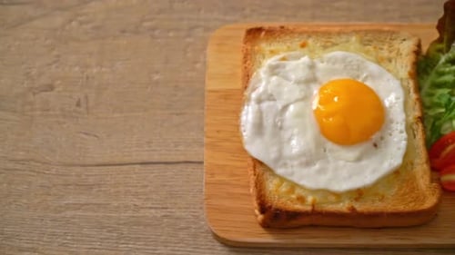 Close Up of Toast with Fried Egg and Salad