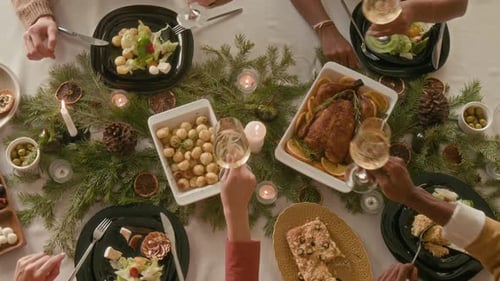 Festive Holiday Dinner Overhead with People Toasting