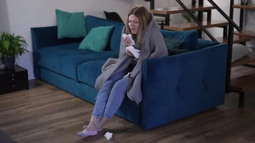 Young Woman Sick with the Flu on Couch
