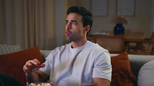 Man Shocked Watching TV While Eating Popcorn