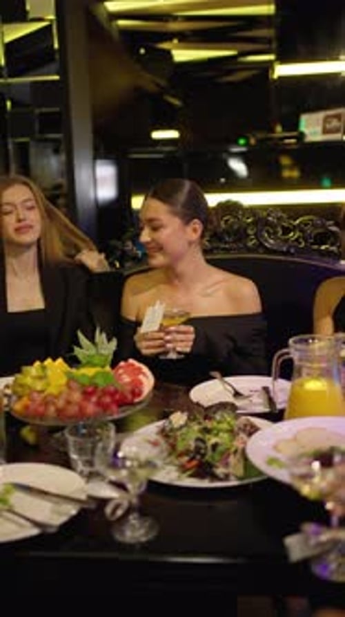 Women are Sitting at Table in Restaurant Concept of Feast in Restaurant