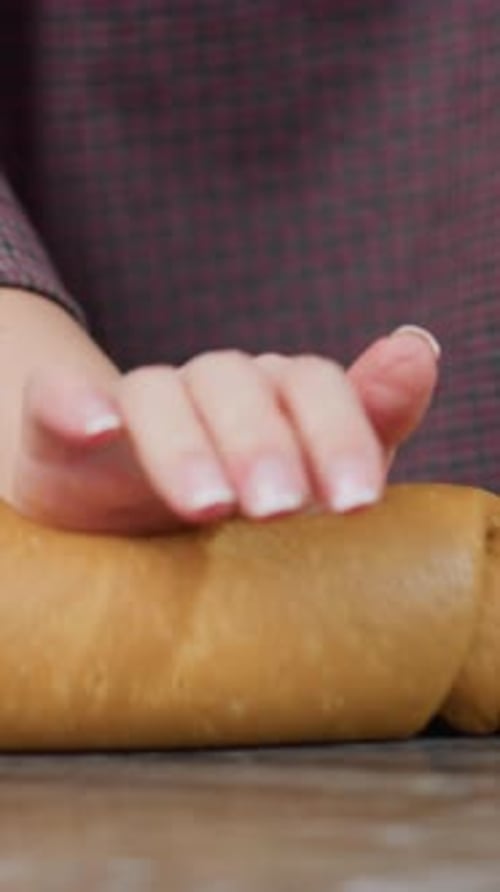 Woman Kneading Fresh Dough with Right Hand on Kitchen Counter with Left Hand Resting