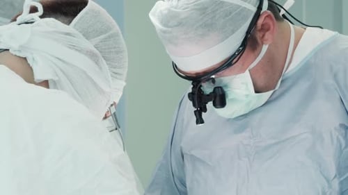 Doctors Performing Surgery in Operating Room