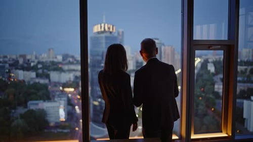 Office Coworkers Looking Evening Cityscape From Panoramic Window Two Partners