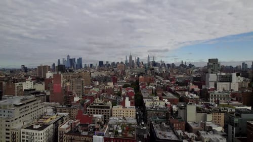 Aerial View Over Brooklyn Borough With Manhattan Skyline In The Distance. Dolly Right, Establishing
