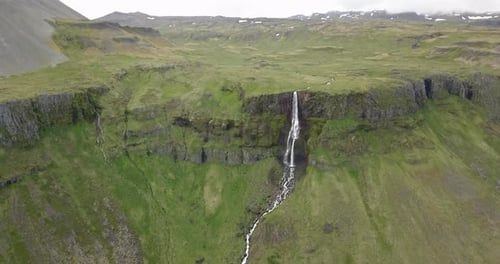 Aerial view of Large waterfall with green landscape in Iceland