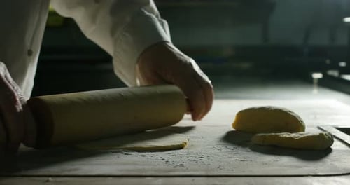 Close up of a baker kneading with his hands to prepare the bread to put in the oven. Concept of: a