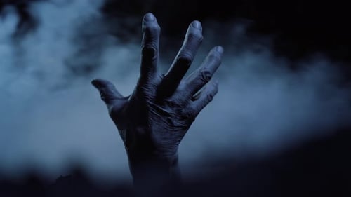 Single Hand Reaching Out in Dark Fog
