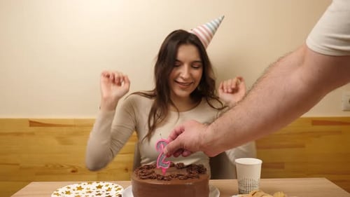 Young Woman Celebrates Birthday with Chocolate Cake