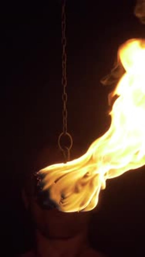 Man is Spitting Fire Cloud Close to Camera Flame Eruption and Burning Vertical Video