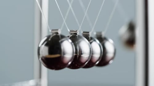 Newton's Cradle with Swinging Metal Sphere