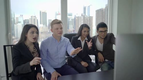 Enthusiastic Team Celebrates Success in Modern Office