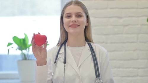 Female Doctor Showing Red Heart, Healthy Life