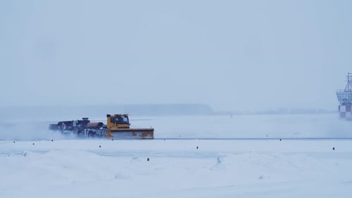 Big Yellow Snow Plow Truck Removes Snow From Airport Runway Snowfall
