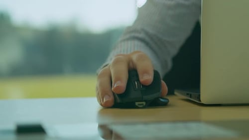 Man Using Computer Mouse At Office Desk