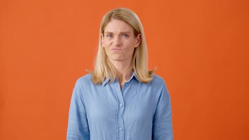 Disappointed Blonde Female Demonstrating Dislike Gesture