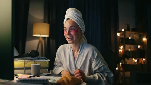 Woman in robe on video call at night