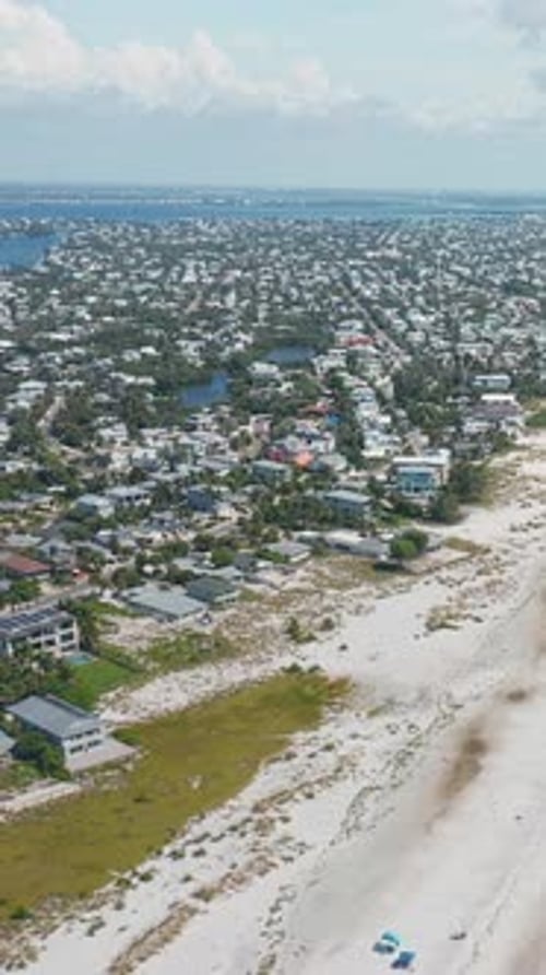 Expansive coastal town with beachfront homes and sandy shoreline