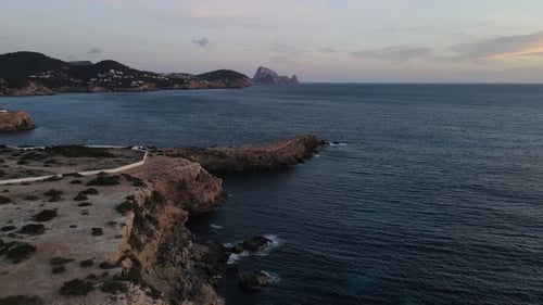 aerial tour of cliff facing the island of Es Vedrá in Ibiza