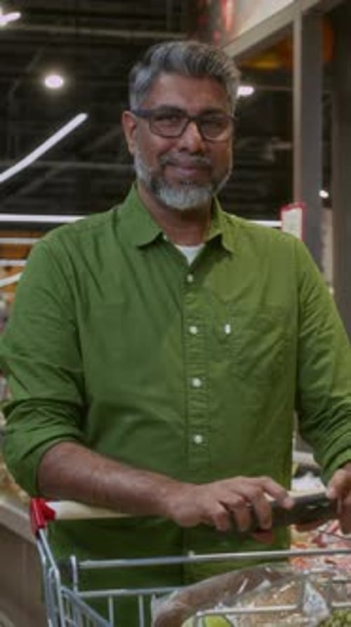 Adult Man Smiling at Camera in Grocery Store