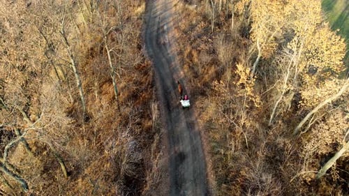 People in a Wagon Loaded with Sacks and Horses Driving Along a Dirt Road