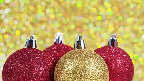 Christmas Balls Rotate on a Golden Background