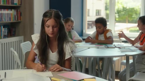 Student Doing Homework and Giving Ok Sign