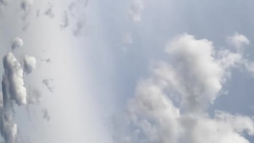Grey cumulus clouds flying at the horizon. Dramatic rainy sky from low angle view. Timelapse.
