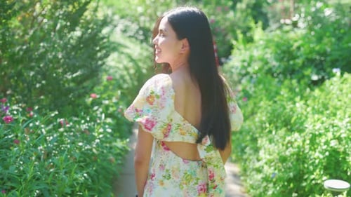 POV shot of a pretty woman is smiling in the garden
