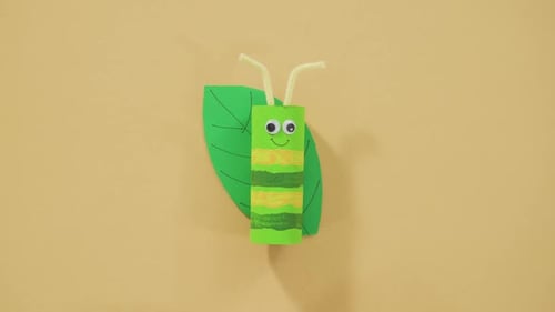 Handmade Paper Caterpillar Craft on Yellow Background