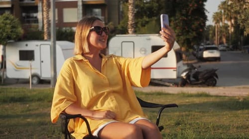 Woman Takes Selfie in Tropical Urban Setting