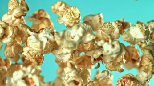 Popcorn Falling in Slow Motion on Light Blue Background