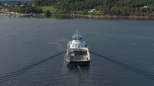 Aerial scene of vehicle ferry in narrow Norwegian fjord waters