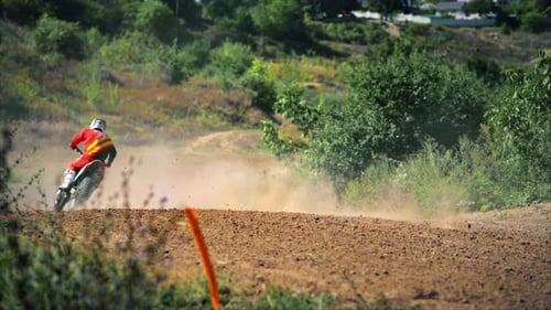 View of riding motorcyclists at a motocross race, mud track, rally motorcycles, greenery around. Slo