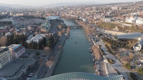 Aerial of Tbilisi City Along the Kura River Traffic Modern Architecture, Georgia