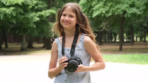 Portrait of Kid Girl Photographer in City Park Child Learning to Take Photos