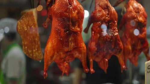 Hanging roasted Peking ducks in a restaurant setting