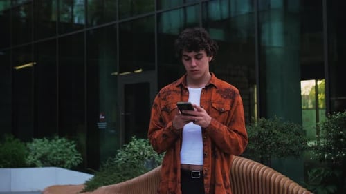 Successful Man Texting Messages on His Modern Smartphone Man in Business District Having Online