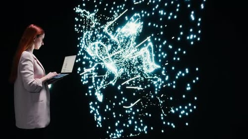 Woman with Laptop Interacting with Abstract Light Display