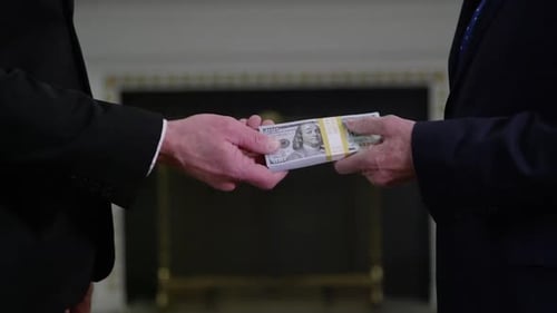 Money in Politics - extreme close up on money hand off HD