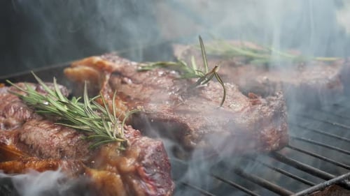 Juicy Grilled Beef Steak with Herbs and Smoke Rising