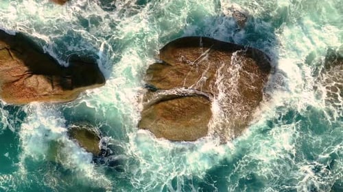 Waves crushing on rocks on the beach.