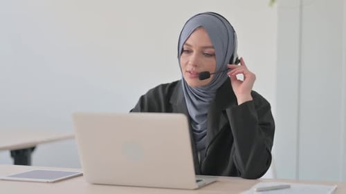 Arab Businesswoman with Headset Talking with Customers Online in Call Centre