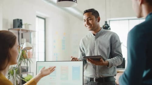 Three Mobile Software Developers Work on Desktop Computer, They Discuss Smartphone Application Desi