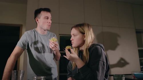 Couple Enjoying Late Night Snack in Cozy Kitchen