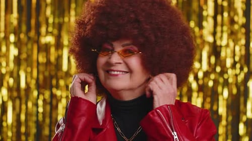 Stylish Senior Woman Posing with Gold Backdrop